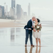 Samantha and Luke kiss after their nuptials are finished at the secret spot at Broadbeach. A bit of wind couldn't spoil their happy day. Surfers Paradise highrise make up the backdrop.