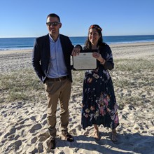Michael and Pierina with their Marriage Certificate on a beautiful Gold Coast beach day