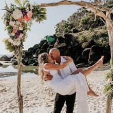 Tania and Jaymal kiss under the arbour on their wedding day 20 September 2022