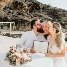 Coralee and Jayce kissing Sue on the beach after their marriage on 27 October 2022